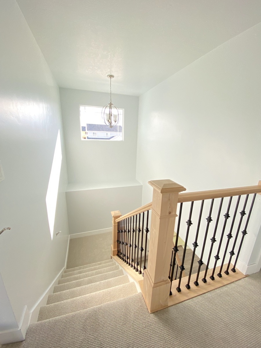 Bright stair landing with a wood and metal railing